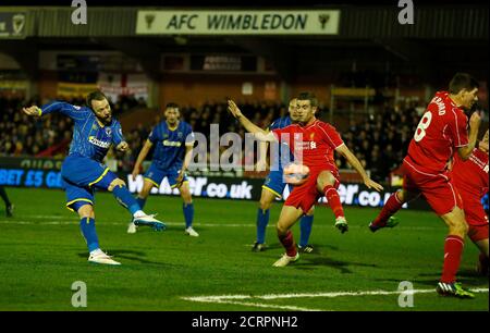 AFC Wimbledon's Sean Rigg (L) shoots but misses during their FA Cup third round soccer match against Liverpool at Kingsmeadow Stadium in Kingston-upon-Thames, southern England January 5, 2015.        REUTERS/Stefan Wermuth (BRITAIN  - Tags: SPORT SOCCER)