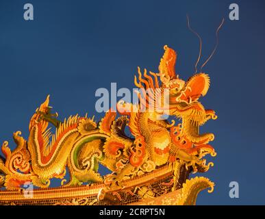 Shot of one of the many dragons on the roofline of a temple in Yokohama’s Chinatown that was originally built in 1862. Generally speaking, dragons are Stock Photo