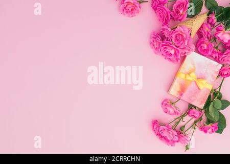 Pink roses flowers and gift box isolated on pink background. Flat lay, Top view. Valentines day concept Stock Photo