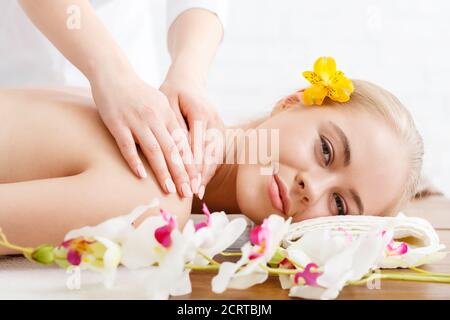 Relaxing in spa. Smiling woman on massage table Stock Photo