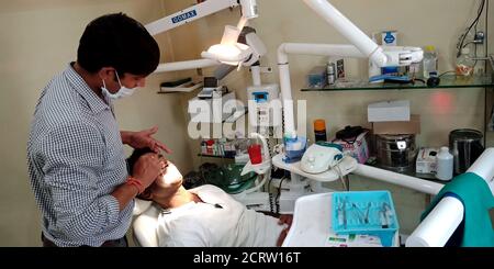 DISTRICT KATNI, INDIA - SEPTEMBER 29, 2019: An indian male dentist checking teeth problem at dental clinic in city hospital. Stock Photo