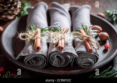 Unique Christmas table setting with napkin and gingerbread cookies on wooden table Stock Photo