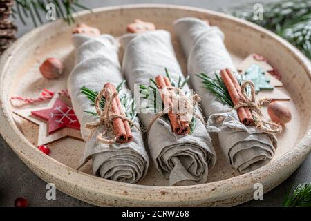 Handmade Christmas table setting with napkin and gingerbread cookies on wooden table Stock Photo