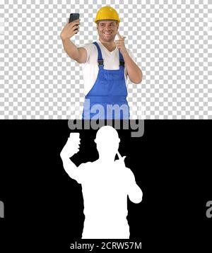Smiling handsome young builder making selfie with mobile phone, Stock Photo