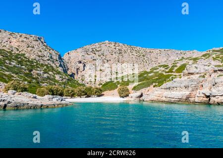 Palatia, Turquoise beach on Saria Island with white chapel above, Karpathos Island, Greece Stock Photo