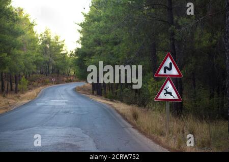 Roadside warning signs, animal may come out and bend sign in Turkey Stock Photo