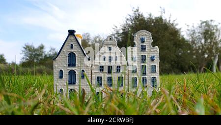 Three hand painted Delftware miniature canal houses, typical Dutch home decoration, selective focus, copy space. Stock Photo