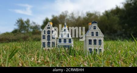 Three blue Dutch Delftware miniature canal houses, hand painted typical Dutch ornamental home decoration, selective focus and copy space. Stock Photo