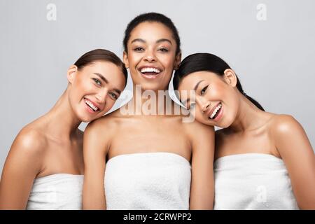 Three Positive Pretty Ladies Posing After Shower In Studio Stock Photo