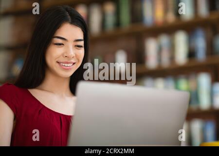 Online Career. Positive Asian Lady Freelancer Working On Laptop In Cafe, Closeup Stock Photo