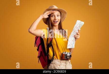 Amazed lady hiker with map doing sightseeing Stock Photo