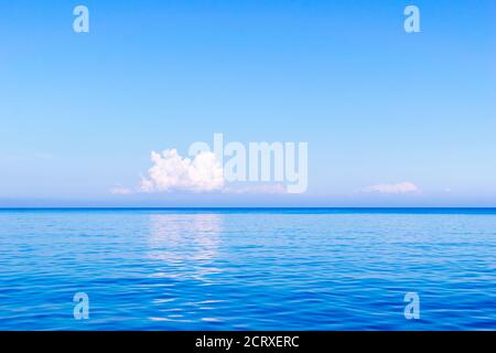 Horizon over Aegean sea with a white cloud in the distance, Karpathos Island, Greece Stock Photo