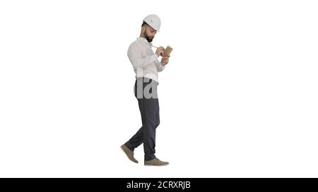 Confident mature man in formalwear and hardhat writing down note Stock Photo