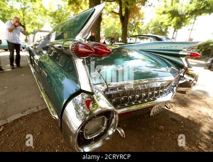 A man takes a picture of a 1959 Cadillac Eldorado Biarritz convertible car during a prologue of the Raid Suisse-Paris 2013 vintage car rally in Zurich August 21, 2013. The Raid Suisse-Paris 2013 runs from August 22 to 25 in Basel. REUTERS/Arnd Wiegmann  (SWITZERLAND - Tags: TRANSPORT)