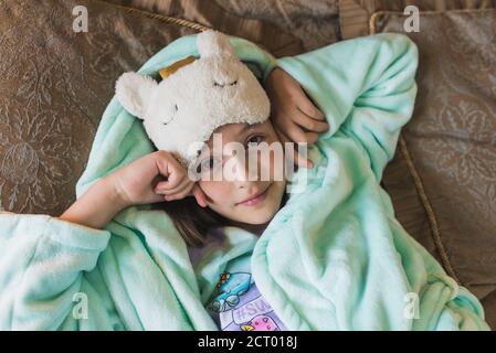 Cute little girl waking up and yawning Stock Photo