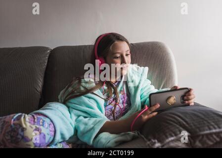 Cute little girl watching videos on the smarthpone Stock Photo