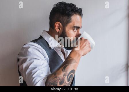 Handsome man dressed as executive  drinking coffee Stock Photo