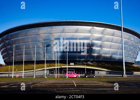 Glasgow / Scotland - Nov 13, 2013: Fall in the city. Clyde river embankment. SSE Hydro building and a pink taxi car. Front view. Empty parking place. Stock Photo