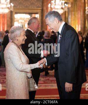 Queen Elizabeth II greets Lee Hsien Loong, Prime Minister of Singapore, in the Blue Drawing Room at Buckingham Palace in London as she hosts a dinner during the Commonwealth Heads of Government Meeting in London, Britain April 19, 2018. Victoria Jones/Pool via REUTERS