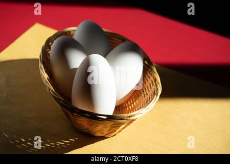 Mortara 04/05/2019: goose eggs composition on red and yellow background Stock Photo
