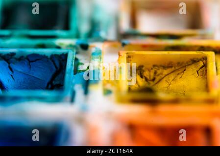 close up of watercolor palette, with focus on yellow and blue. Stock Photo