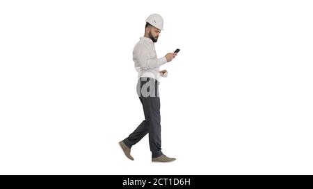 Engineer walking and using smartphone on white background. Stock Photo