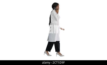 African american female doctor talking on the phone while walkin Stock Photo