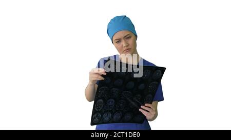 Female doctor looking at brain tomography on white background. Stock Photo