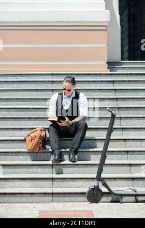 Smiling man writing in planner Stock Photo