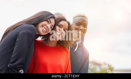 Multi ethnic friends outdoor on photo shooting looking at camera. Diverse group people Afro american asian spending time together Multiracial male fem Stock Photo