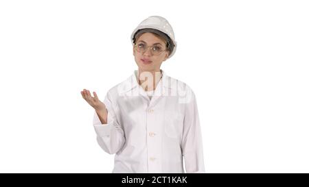 Mature engineer woman in hard hat and lab coat talking and prese Stock Photo