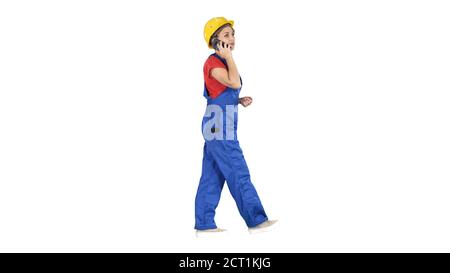 Young female architect consultant talking on phone while walking Stock Photo