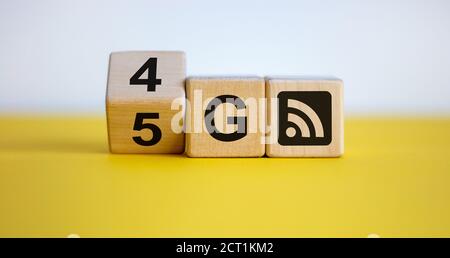 Symbol of the change from 4G to 5G. Changed wooden blocks from 4G to 5G. Technology, network, communication concept. Beautiful yellow table, white bac Stock Photo