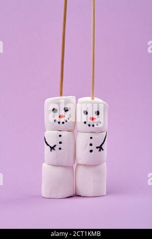 Two happy funny marshmallow snowmen. Stock Photo