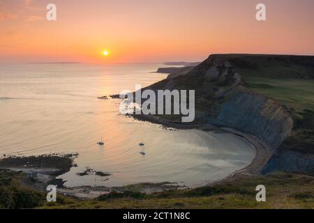 Worth Matravers, Dorset, UK.  20th September 2020.  UK Weather.  The sky glows orange at sunset above Chapmans Pool and the cliffs of Houns Tout on the Jurassic Coast near Worth Matravers in Dorset during the last few days of the autumn heatwave before the weather is forecast to cool down.  Picture Credit: Graham Hunt/Ģ����ý Live News Stock Photo