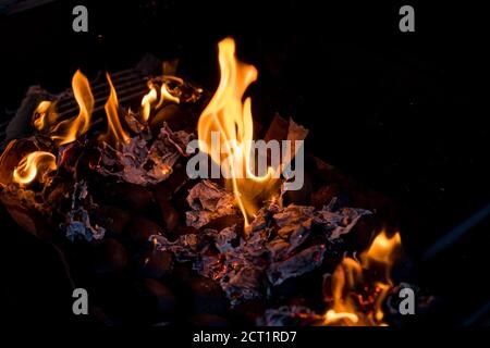 Barbecue Fire Grill on Black Background.burning charcoal. Focus is on Hot coals in the fire.burning charcoal background with fire and sparks.The coals Stock Photo