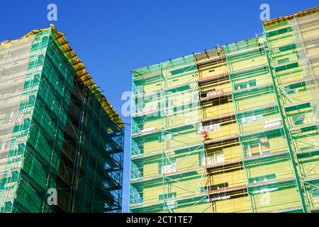 scaffolding arround the house to install thermal insulation of the apartment building facade Stock Photo