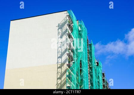 scaffolding arround the house to install thermal insulation of the apartment building facade Stock Photo