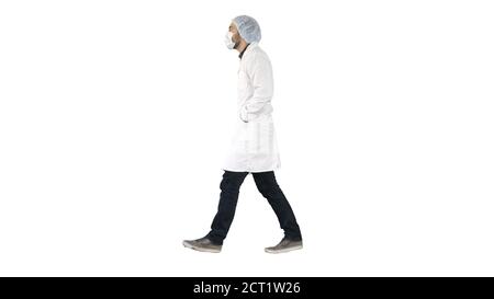 Walking doctor puting medical mask on on white background. Stock Photo