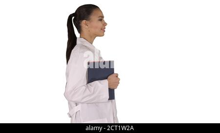 Happy smiling female doctor walking holding notebooks or documen Stock Photo