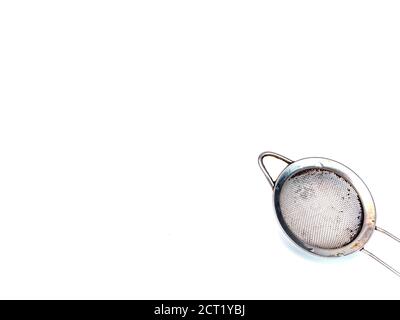 Metal strainer for coffee and tea on a white background. Making tea and coffee. Hot drinks. Kitchen tool. Filter. Home kitchen. Background image. Plac Stock Photo