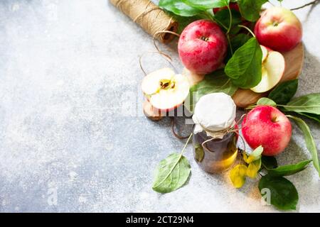 Apple vinegar. Healthy organic food. A bottle of apple cider vinegar on a light stone countertop. Copy space. Stock Photo