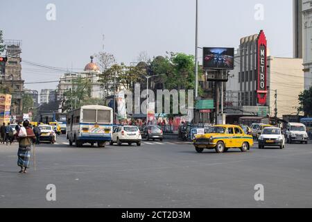 Kolkata, India - February 1, 2020: Unidentified people walks on the street while buses and cars drives past in traffic on February 1, 2020 in Kolkata Stock Photo