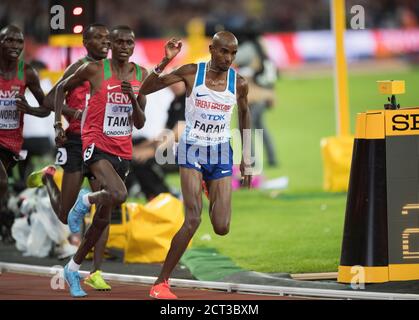 Mo Farah is tripped by Tanui and almost falls on his way to winning the 10,000m.  World Athletics Championships 2017 The London Stadium  Copyright Pho Stock Photo