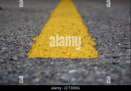 detail of a horizontal yellow line painted on the asphalt Stock Photo