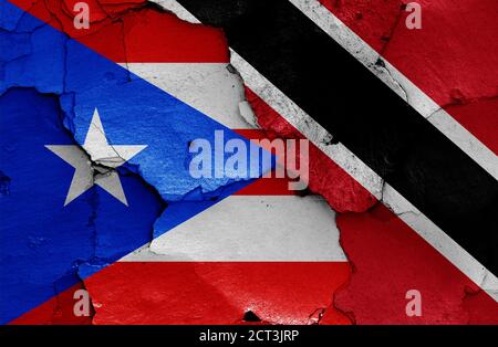 flags of Puerto Rico and Trinidad and Tobago painted on cracked wall Stock Photo