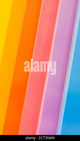 background texture-vibrant rainbow stripes painted diagonally on weathered wood Stock Photo