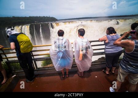 Tourists at The Devil's Throat, Iguazu Falls (aka Iguassu Falls or Cataratas del Iguazu), Misiones Province, Argentina, South America Stock Photo