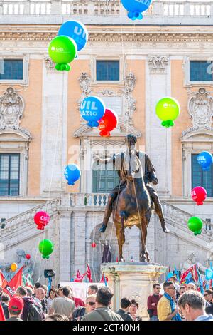 Rome Italy Equestrian statue of Emperor Marcus Aurelius on Piazza del Campidoglio Capitoline Hill in front of Roman City Hall with union protesters. Stock Photo