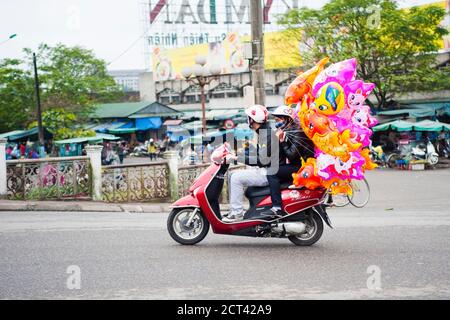 Moped Carrying Hellium Ballons, Driving along the Streets of Hue, Vietnam, Southeast Asia Stock Photo